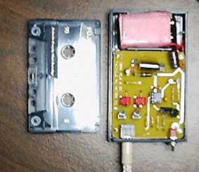 [photo: the VU meter with its cover removed and shown next to a standard cassette tape for scale]